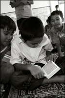 A boy reads the Koran after the midday prayer at an orphanage in Banda Aceh Indonesia