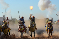Fantasia - Riders grimace amongst  the gunpowder smoke and muzzle blasts